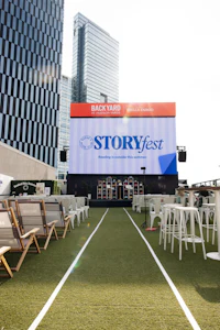a large screen in the middle of a grassy field