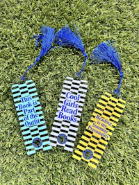 three bookmarks with tassels on the grass